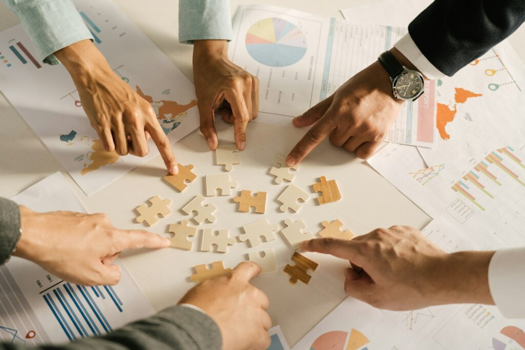 The concept of teamwork and partnership. Businessman's hands putting together puzzle