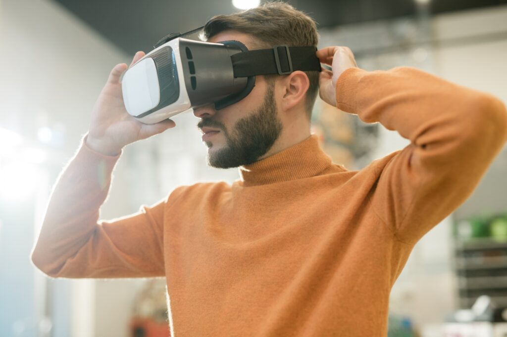 Casual guy putting vr goggle on head to find himself in virtual shop