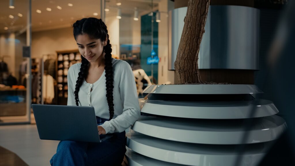 Latina businesswoman student shopper work on laptop at shopping mall make order online retail sales