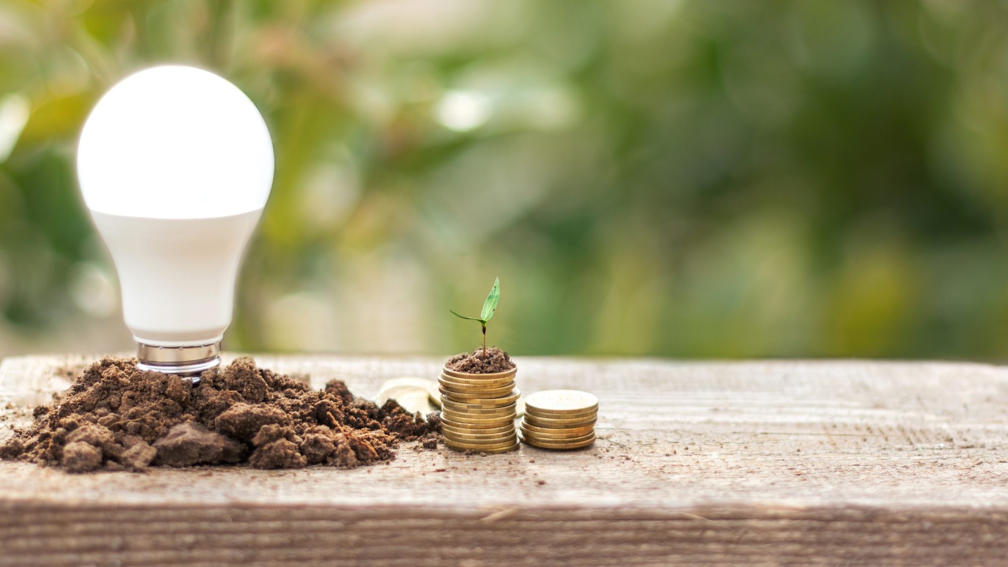 LED Bulb and Coin stack - Saving concept, electric and eco business, economical consumption