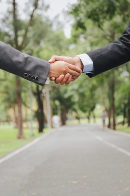 Businessmen hand shaking at the park